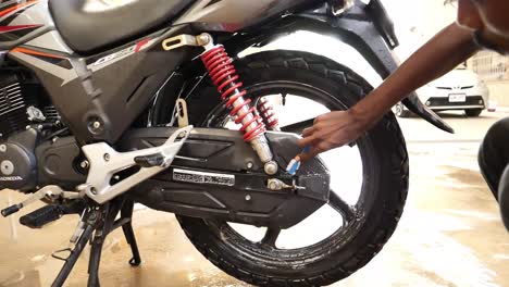 Detailer-Using-Small-Brush-On-Rim-Of-Honda-CBF150F