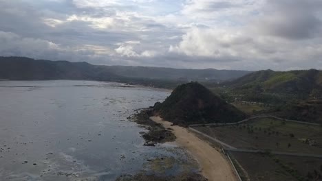 Magnetic-sky-with-magnificent-clouds-over-a-nature-park-Buttery-soft-aerial-view-flight-sinking-down-drone-footage-Pantai-Kuta-Lombok-Indonesia-2017-Cinematic-view-from-above-Guide-by-Philipp-Marnitz