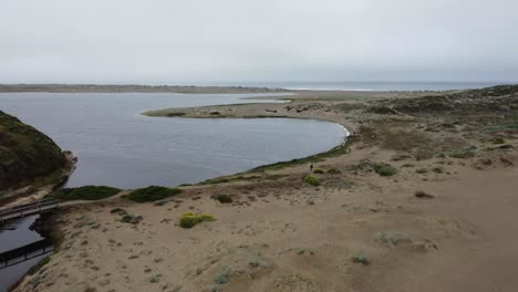 Drone-Flying-Over-Beautiful-Blue-Sea-shore,-Magical-Sand,-California