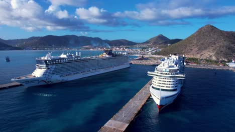 Cruise-ships-docked-at-port-of-Philipsburg,-Sint-Maarten-near-Great-Bay-Beach---Aerial-left-dolly-at-constant-altitude-during-calm-sunset