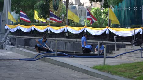 Workers-cleaning-a-fountain-pond-in-Bangkok