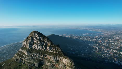 Lions-Head-mountain-peak-at-sunset-with-view-of-Cape-Town-city-bowl-in-South-Africa,-aerial