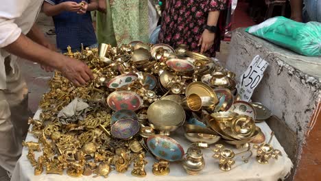 A-brass-seller-shows-brass-statues-to-the-buyers-at-Janpath-market-in-New-Delhi