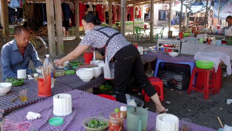 Vietnamese-middle-class-feasting-at-a-street-side-stall-at-Dong-Ba-food-market