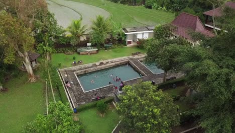 aerial-drone-view-of-hot-springs-from-the-ancient-kingdom,-named-umbul-temple-in-central-java,-indonesia