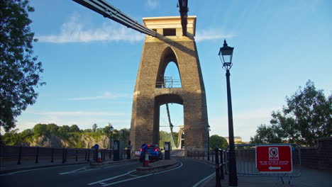 Blue-Skies-as-Motorcars-Drive-through-Archway-of-Clifton-Suspension-Bridge,-Bristol,-England---loop-timelapse