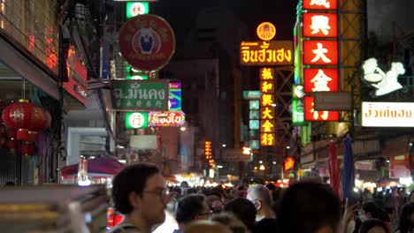 Many-travelers-people-in-Yaowarat-Road-Chinatown,-popular-travel-destination-in-Bangkok,-Thailand