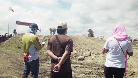 Onlookers-watch-out-for-motorcycles-at-the-finish-line-of-the-highly-anticipated-motocross-competition-in-Cadiz-City