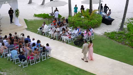 Groomsman-and-bridesmaid-walk-down-the-aisle-at-outdoor-tropical-destination-wedding