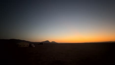 Camp-and-tent-in-middle-of-Sahara-Desert-sand-at-beautiful-sunrise