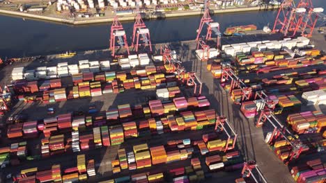 Aerial-birds-eye-shot-of-international-storing-container-at-port-of-Buenos-Aires-with-industrial-cranes-at-sunset