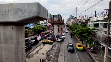 Unfinished-Sky-Train-Pillar-with-Traffic-Jam-Below,-Thailand