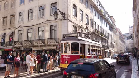 Old-Tram-with-Tourists-in-Historical-City-Center-of-Lisbon-in-Portugal