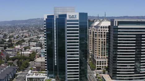 Aerial-view-around-the-blue-shield-headquarters,-summer-day-in-Oakland,-USA---orbit,-drone-shot