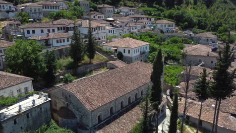 Drone-shot-of-the-Albanian-UNESCO-world-heritage-Berat---drone-is-ascending-from-a-traditional-house-in-the-village