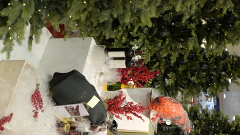 Vertical-shot-of-xmas-decorations-beverages-surrounded-by-Christmas-trees