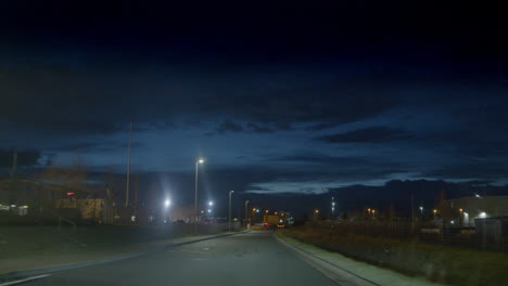 Evening-Scenery-of-Moving-Street-Lights-out-of-Car-After-Dark-Rises