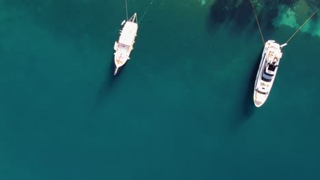Aerial-view-above-two-yachts-tied-to-shore-in-Miljet-island-Croatia