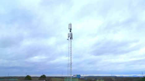 Approaching-Towards-Telecommunication-Tower-Against-Cloudy-Sky