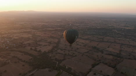 Hot-air-balloons-over-plains-of-Bagan,-Myanmar-during-golden-sunrise