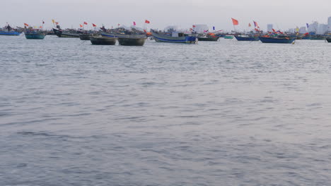 Dolly-shot-along-the-seafront-of-Da-Nang-with-fishermen-heading-out-to-sea