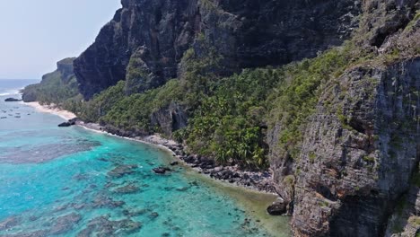 Establish-rocky-beach-with-turquoise-blue-water,-paradise-island,-drone-aerial