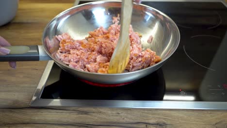 Woman-Stirring-Minced-Meat-in-a-Frying-Pan-with-Wodden-Spoon