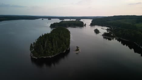Aerial-of-dusk-lake-islands,-Sweden