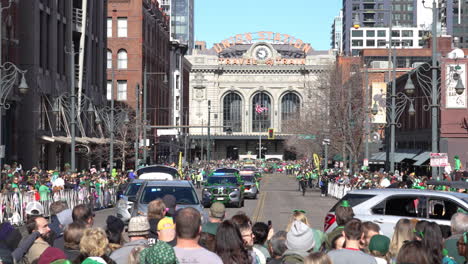 Police-cars-with-flashing-lights-driving-slowly-through-a-downtown-St