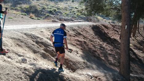 People-running-a-mountain-marathon-on-arid-roads