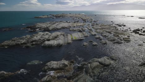 Flying-over-one-of-the-rocky-reefs-in-Kaikoura-New-Zealand,-a-fantastic-dive-spot-for-tourist