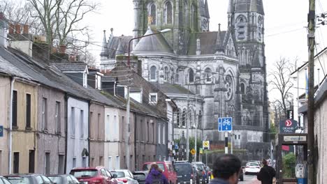 Overcast-day-on-the-R608-in-Cork-City-with-regular-traffic-and-view-to-St-Fin-Barre's-Cathedral,-Ireland
