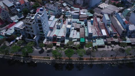 Vietnam,-Ho-Chi-Minh-City-District-six-aerial-view-on-a-sunny-day-featuring-the-canal,-houses,-park-and-road-traffic