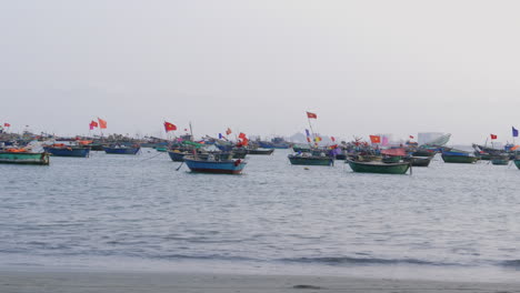 Dolly-shot-along-Da-Nang-beach-with-hundreds-of-boats-docked-in-the-ocean