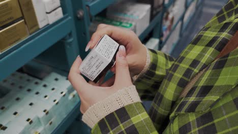 Woman-looking-at-cosmetic-product-at-Chinese-retail-store-and-reading-product-information