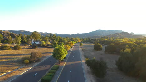 Aerial-drone-shpt-of-cars-driving-on-a-road-in-Ramona-California