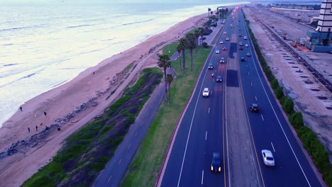Drone-footage-of-traffic-on-Pacific-Coast-Highway,-along-the-coast-of-California