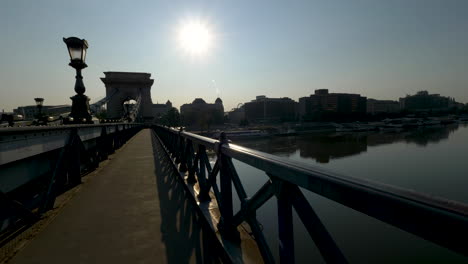 Walking-through-Chain-bridge-at-sunrise,-Budapest,-Hungary