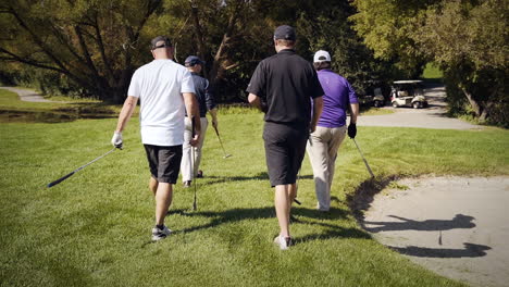 Group-of-golfers-walking-back-to-their-cart-in-slow-motion