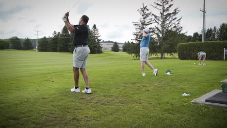 Golfers-teeing-off-on-a-driving-range-at-a-golf-course-in-slow-motion