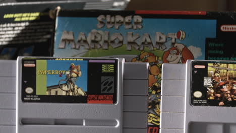 Vintage-Super-Nintendo-Cartridges-with-Box-in-Background-SLIDE-LEFT