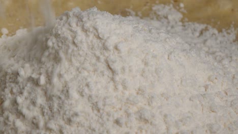 Close-up-shot-of-pouring-flour-on-a-pile-in-slow-motion