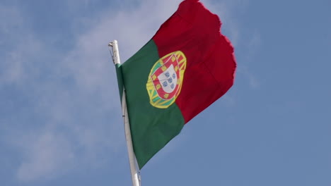 Portugal-waving-flag-with-sligth-clouds-monivng-in-the-backrouwnd