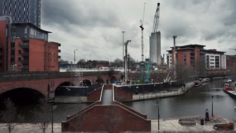 Wide-shot-of-construction-site-next-to-canal-area-in-Manchester-city-centre
