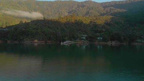 SLOWMO---Aerial-flying-over-sea-towards-beach-in-Marlborough-Sounds,-New-Zealand,-cinematic-morning-shot