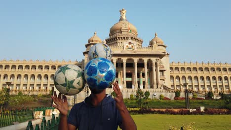 Ein-Künstler,-Der-Am-Frühen-Morgen-Tricks-Mit-Fußbällen-Vor-Dem-Vidhana-Soudha-Gebäude-In-Bengaluru,-Karnataka,-Indien,-Vorführt