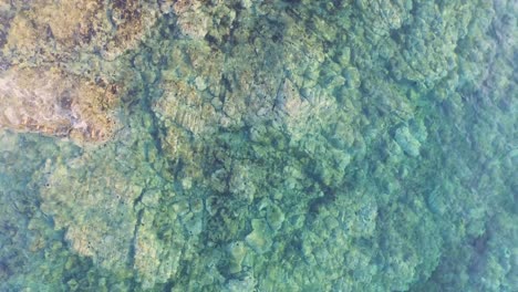 Aerial:-Top-down-view-of-clear-blue-water-in-Greece