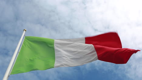 Italian-green,-white-and-red-flag-waving-in-a-strong-wind-with-a-royal-blue-sky-and-clouds-in-the-background-seen-from-underneath
