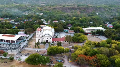 Aerial-panning-of-Filipino-Catholic-Church-in-Oslob,-Our-Lady-of-Immaculate-Conception-Church-Cebu,-Philippines