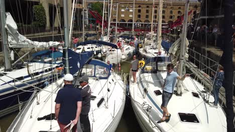Luxury-yachts-with-owners-waiting-to-set-sail-on-the-Thames-from-St-Katherine-Dock-Marina,-London,-UK